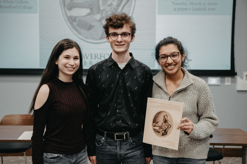 The three student speakers at the exhibition opening, Rachel Schiffer, Aidan Chapin, and Natasha Bansal, pose with the exhibition catalog. 