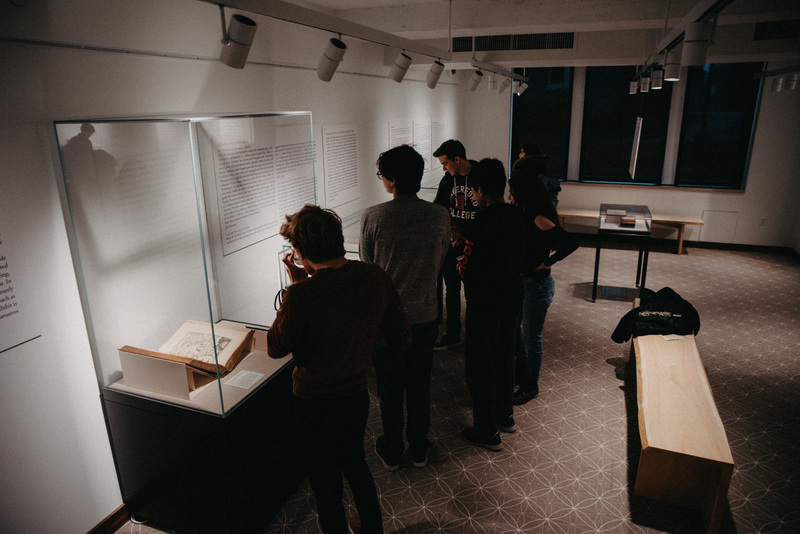 Students view the exhibition during the opening reception. 
