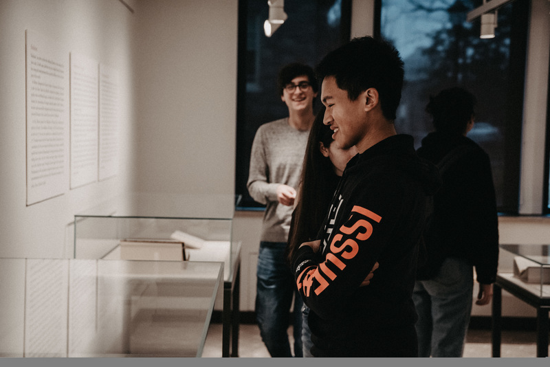Student, Dylan Soemitro, views the installed exhibition during the opening reception. <br />
